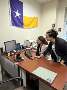 Dr. Dumas and Esme review project data on the computer. 